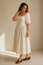 Ivory linen a-line midi dress, three-quarter view, puff sleeves and gathered A-line skirt