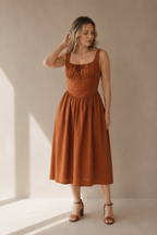 Rust linen a-line midi dress, full front view, a-line skirt and side pockets