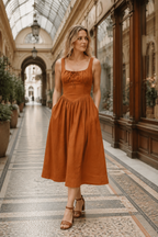 Rust linen a-line midi dress, lifestyle, relaxed afternoon in natural light