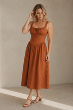 Rust linen a-line midi dress, three-quarter view, flowing skirt and comfortable silhouette
