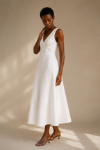 White linen a-line midi dress, three-quarter view, gentle skirt flare, natural fabric drape