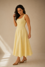 Butter yellow linen a-line midi dress, three-quarter view, flowing A-line skirt, gentle drape