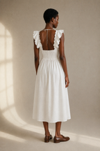 White linen a-line midi dress, back view, fitted bodice and skirt release