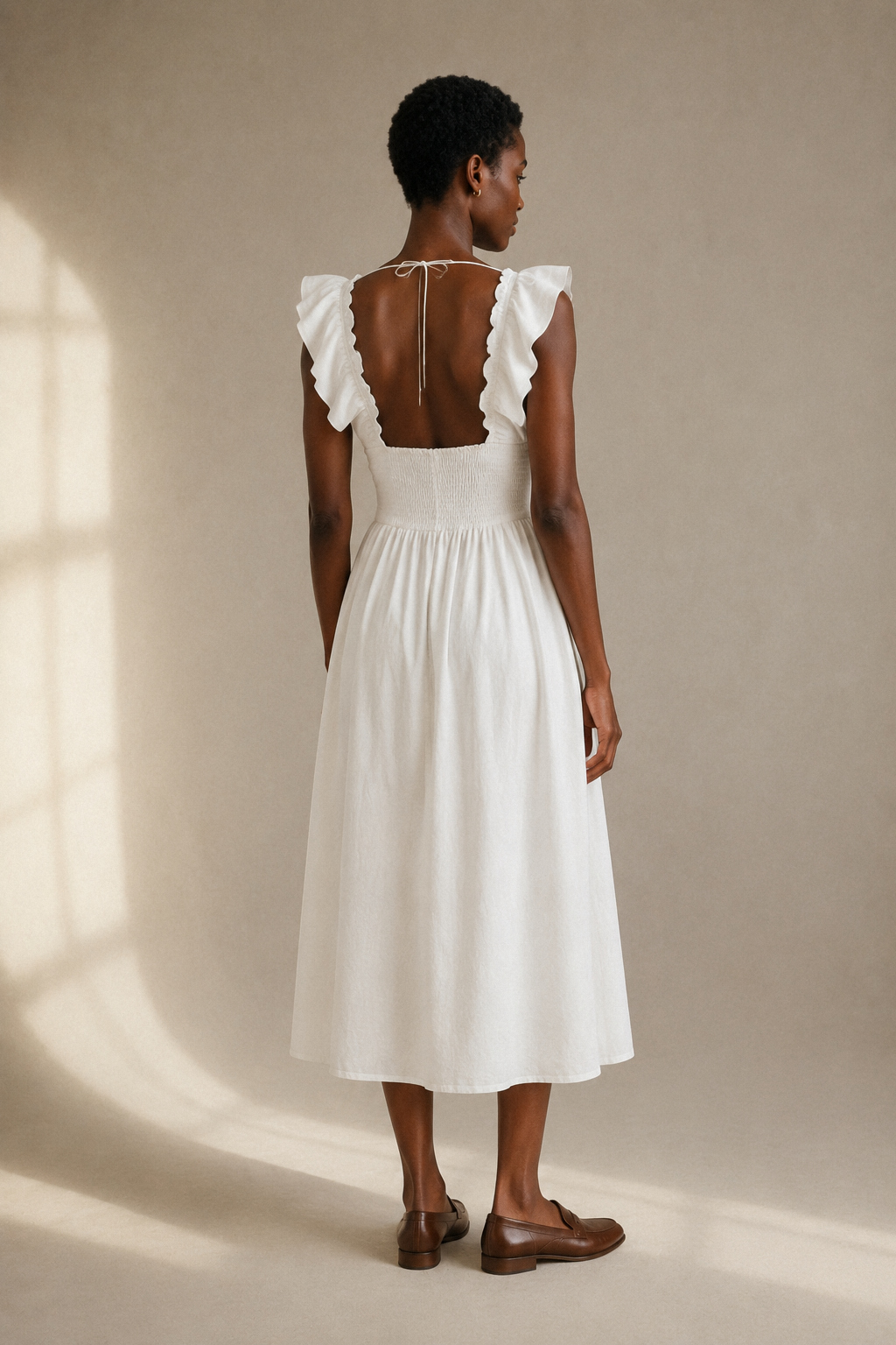 White linen a-line midi dress, back view, fitted bodice and skirt release