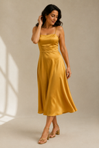 Golden yellow silk slip midi dress, three-quarter view, bias cut silk drape