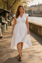 White linen a-line midi dress, lifestyle, sunny room with fresh citrus