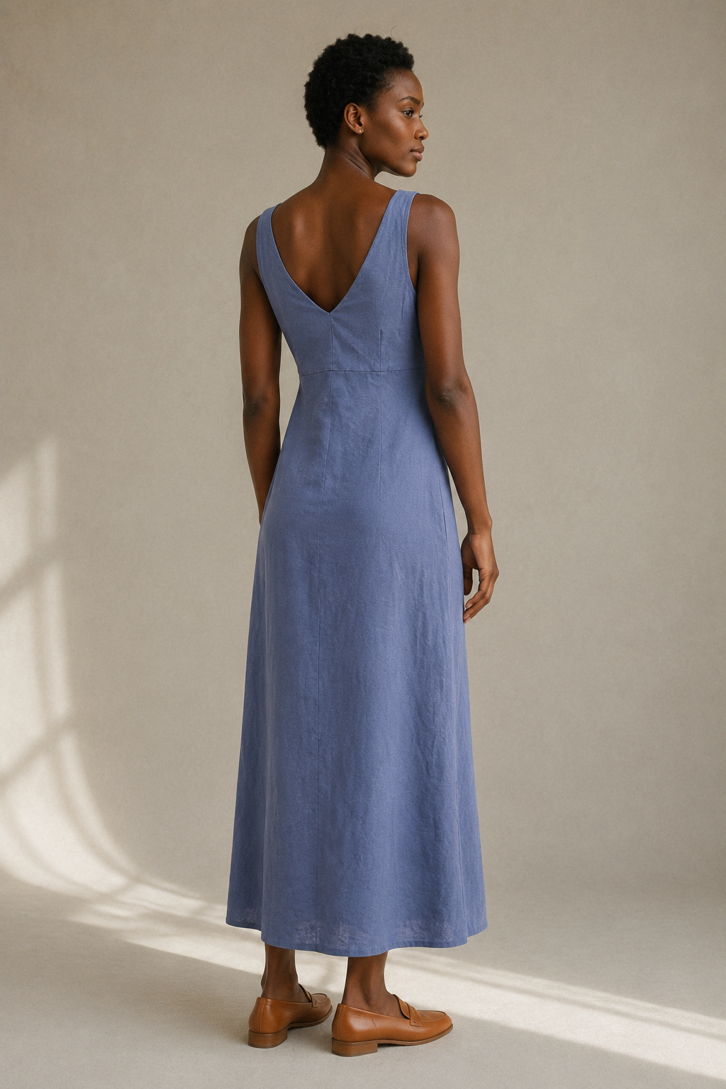 Dusty blue linen a-line midi dress, back view, deep V-back and waist seam