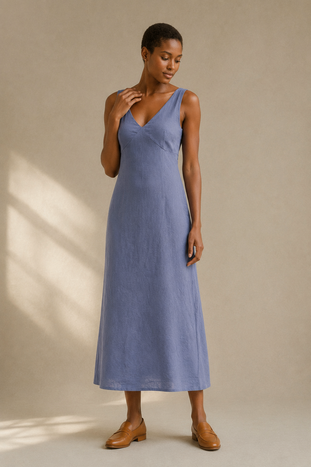 Dusty blue linen a-line midi dress, full front view, sleeveless bodice and flowing skirt