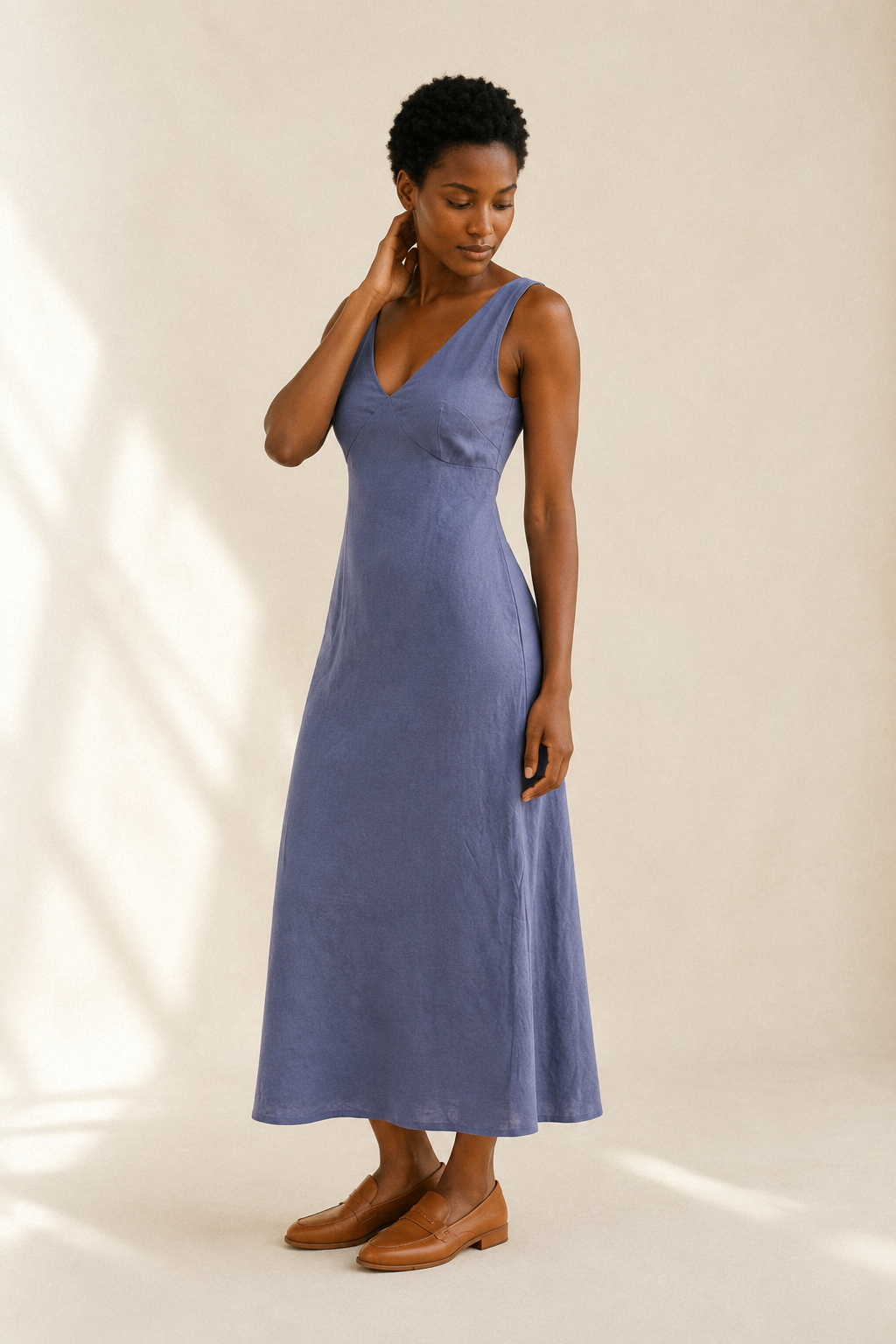 Dusty blue linen a-line midi dress, three-quarter view, a-line silhouette with graceful drape