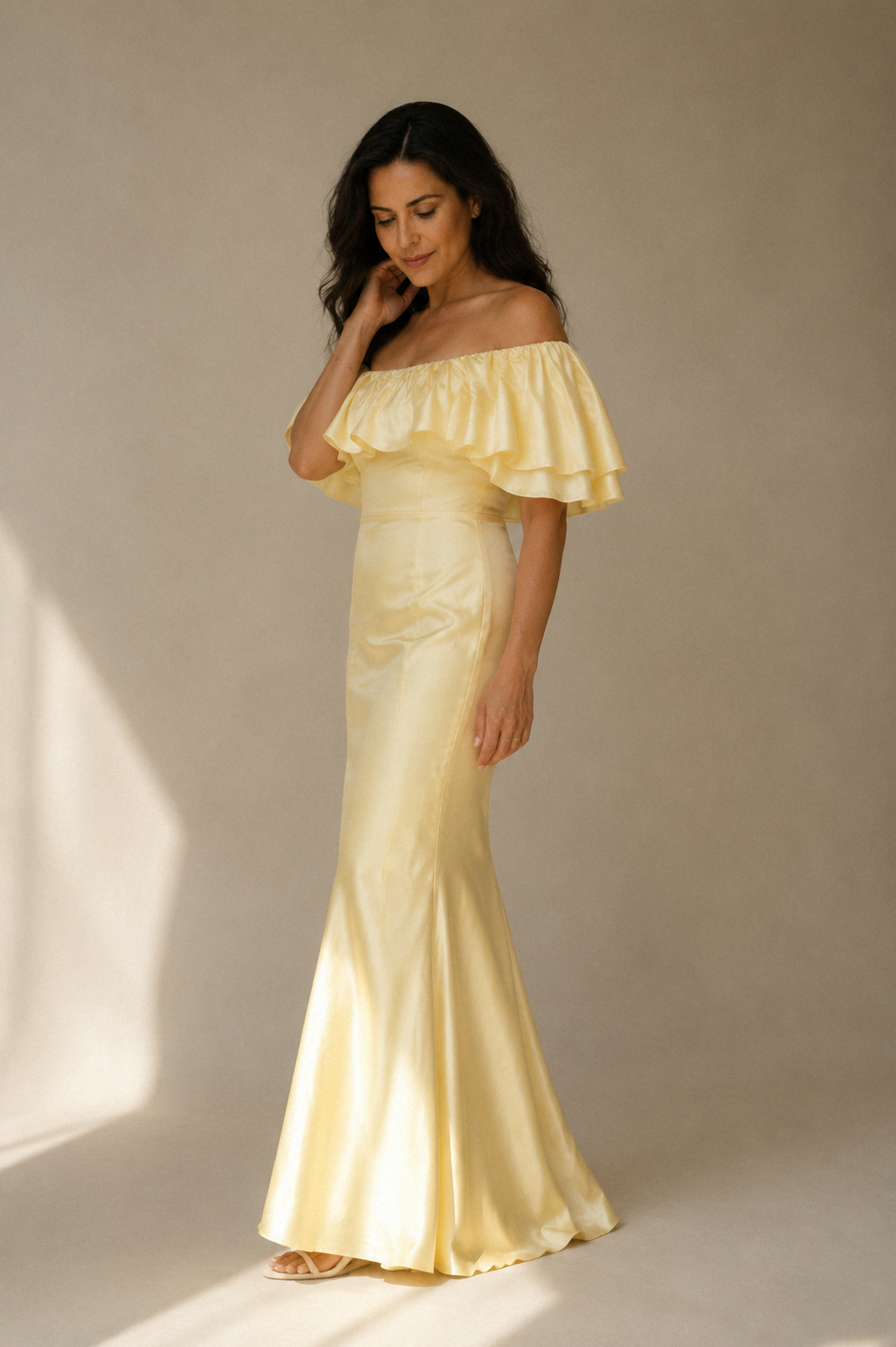Butter yellow silk column midi dress, three-quarter view, off-shoulder neckline and fitted column dress