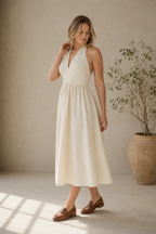 Ivory linen a-line midi dress, three-quarter view, halter neck and flowing skirt
