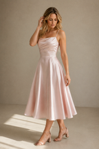 Light pink silk a-line midi dress, three-quarter view, flowing skirt and graceful movement