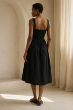 Black linen a-line midi dress, back view, clean back and full skirt