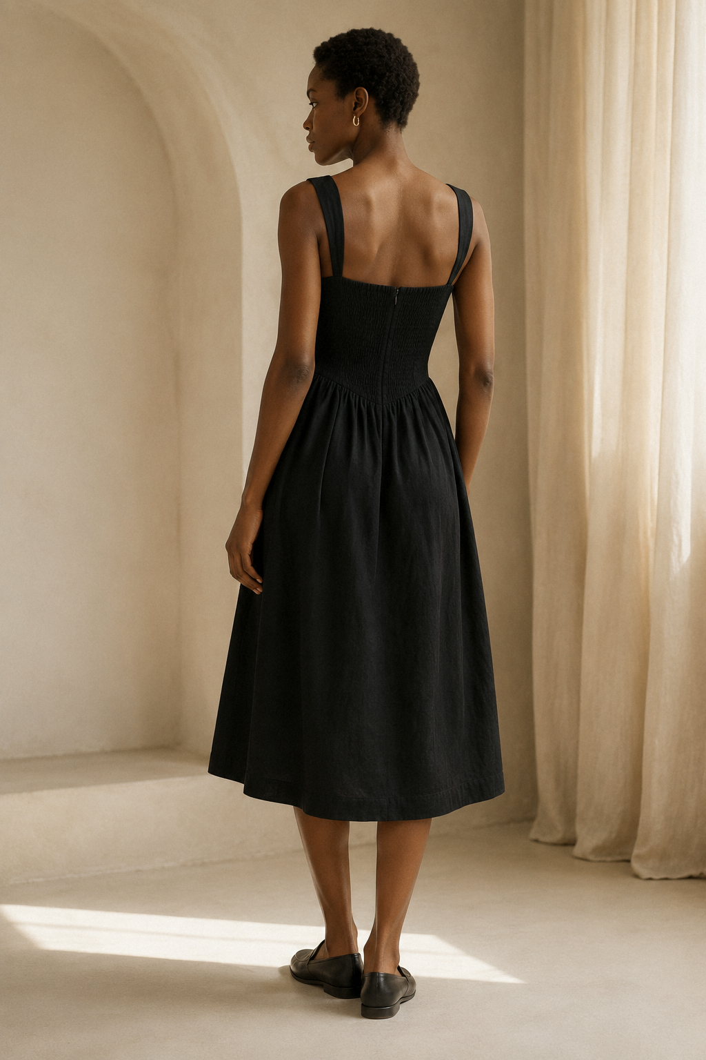 Black linen a-line midi dress, back view, clean back and full skirt