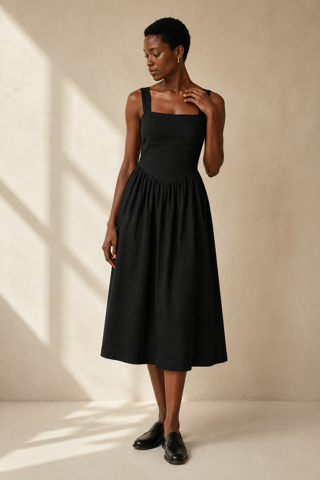 Black linen a-line midi dress, full front view, fitted bodice and flowing skirt