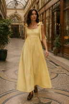 Butter yellow linen a-line midi dress, lifestyle, afternoon light, quiet courtyard