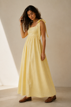 Butter yellow linen a-line midi dress, three-quarter view, soft drape and relaxed silhouette
