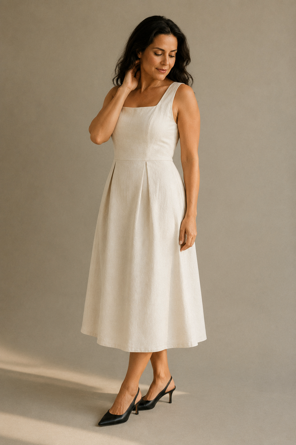 Ivory linen a-line midi dress, three-quarter view, sleeveless bodice with pleated midi skirt