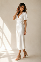Ivory silk column midi dress, three-quarter view, subtle waist seam and flowing skirt