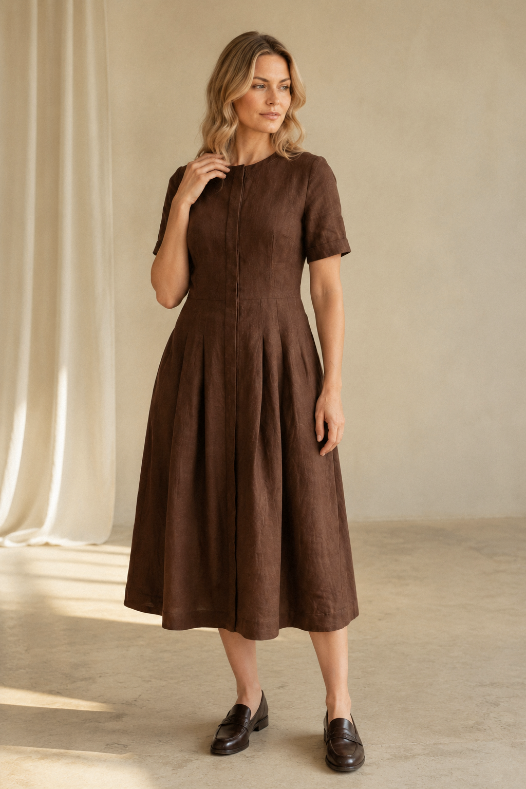 Brown linen a-line midi dress, full front view, fitted bodice, full skirt, side pockets