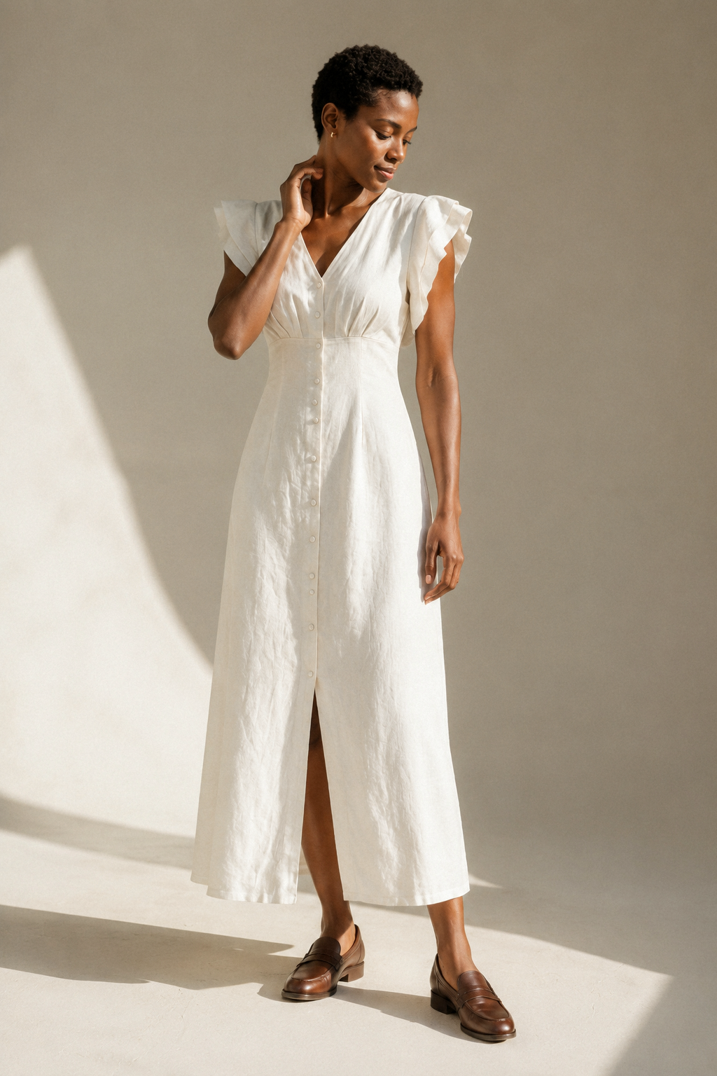 Ivory linen a-line midi dress, three-quarter view, flutter sleeves and natural fabric drape