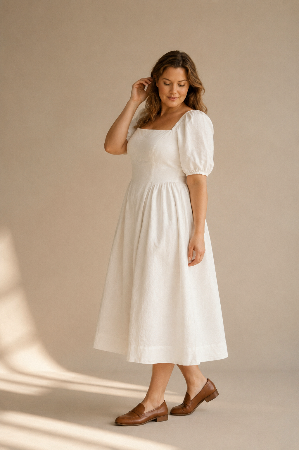 Ivory linen a-line midi dress, three-quarter view, open back and puff sleeves
