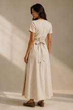 Beige linen wrap midi dress, back view, adjustable wrap, fluid silhouette
