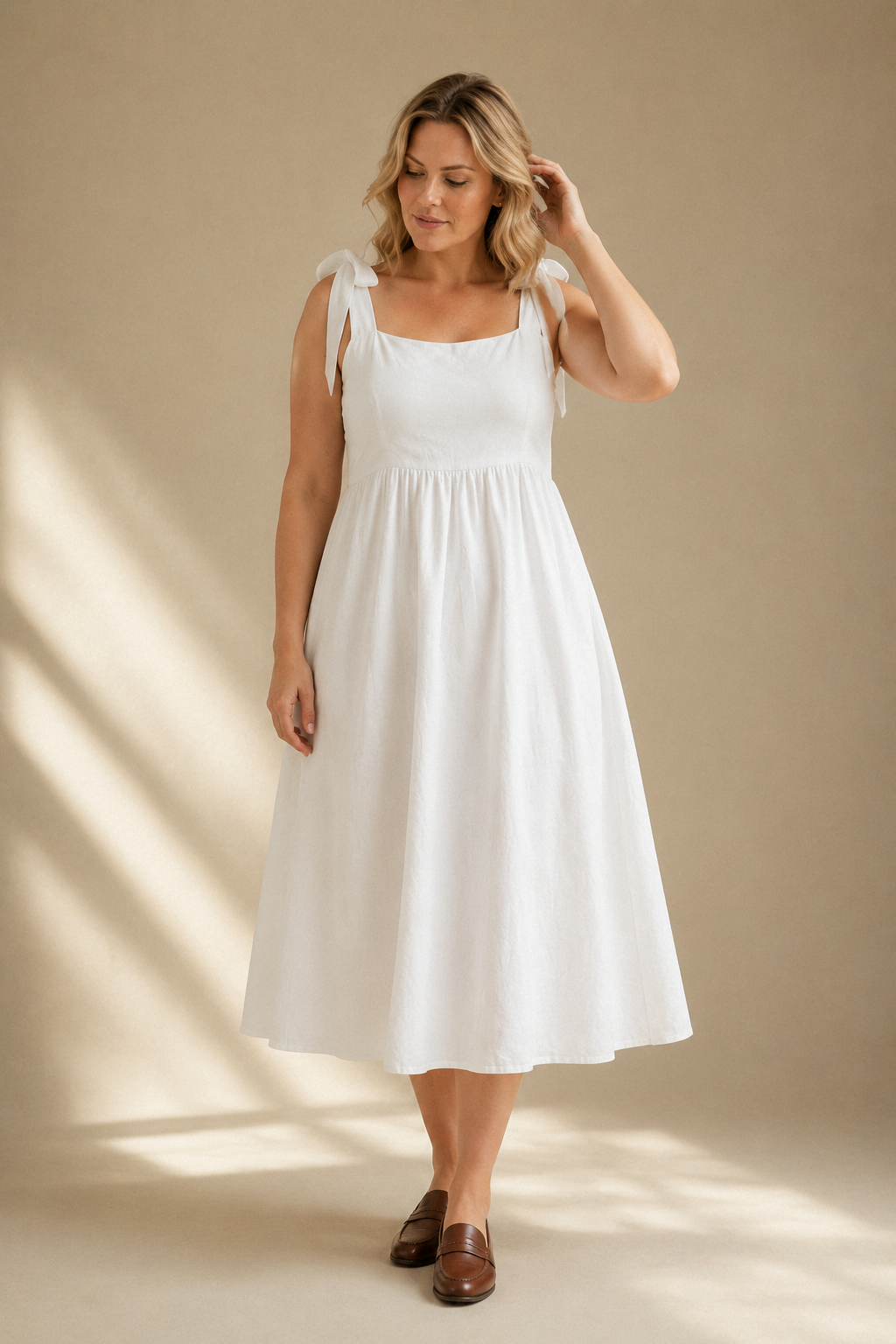 White linen a-line midi dress, full front view, gathered waist and flowing A-line skirt
