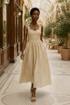Light beige linen a-line midi dress, lifestyle, sunny room, relaxed posture