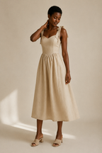 Light beige linen a-line midi dress, three-quarter view, flowing midi skirt, soft linen drape