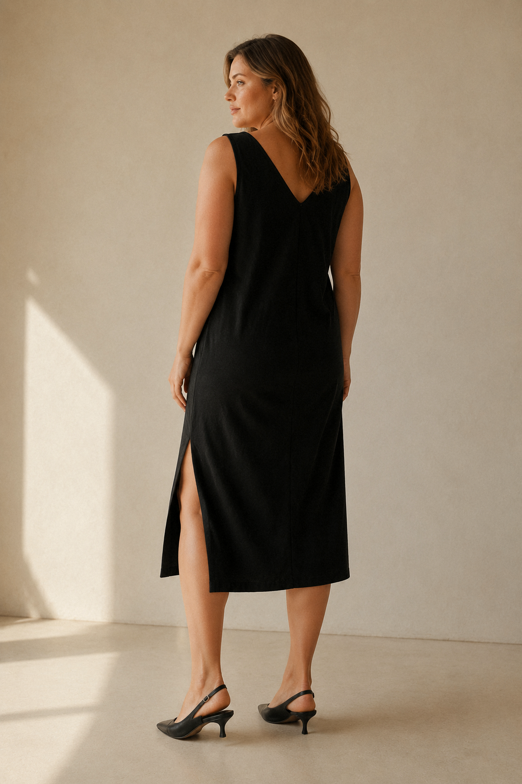 Black cotton shift midi dress, back view, straight back and clean lines