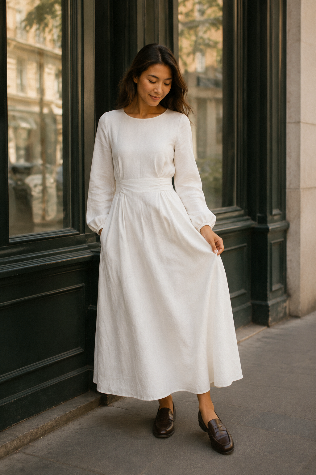 White linen a-line midi dress, front view, round neckline, long sleeves, waist sash