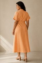 Peach linen wrap midi dress, back view, fluid drape and relaxed fit