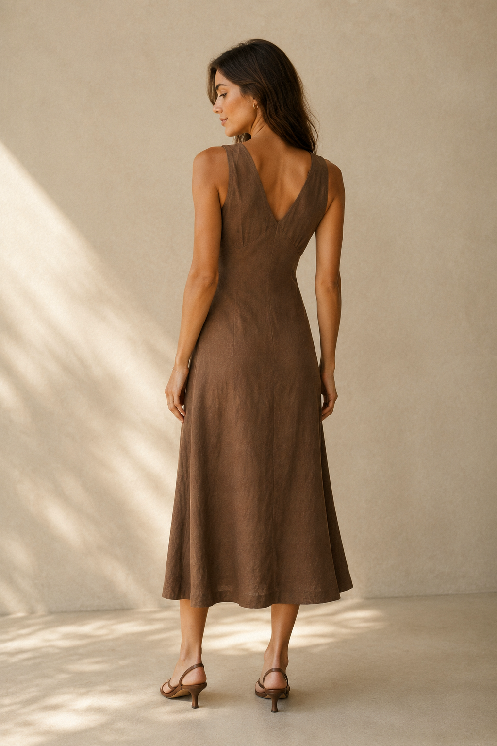 Brown linen a-line midi dress, back view, fitted bodice and flowing A-line skirt