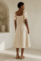 Beige linen a-line midi dress, back view, defined waist and fluid skirt