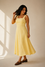 Butter yellow linen a-line midi dress, three-quarter view, relaxed A-line shape, soft drape