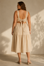 Beige linen tiered midi dress, back view, back tie closure and cutout waist