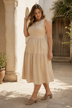 Beige linen tiered midi dress, three-quarter view, tiered skirt and back tie detail