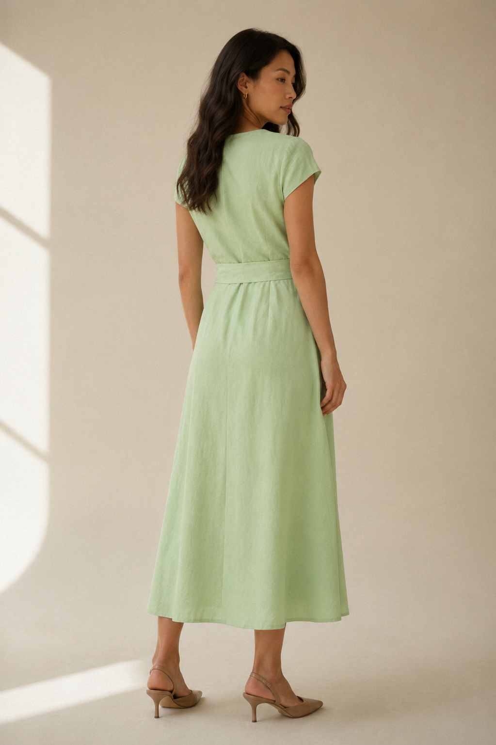 Light green linen wrap midi dress, back view, smooth back with defined waist