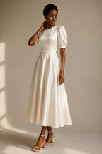 Ivory silk a-line midi dress, three-quarter view, waist definition and skirt movement
