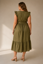 Olive green linen tiered midi dress, back view, defined waist, flowing skirt