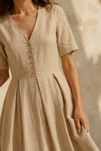 Beige linen a-line midi dress, fabric detail, flax weave in raking light