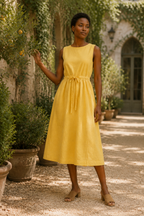 Yellow linen a-line midi dress, lifestyle, sunlit stroll by a white wall