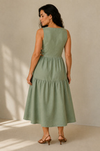 Sage green linen tiered midi dress, back view, side cut-out with back tie