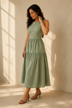 Sage green linen tiered midi dress, three-quarter view, tiered skirt and side cut-outs