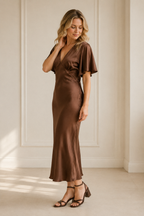 Brown silk column midi dress, three-quarter view, flowing silhouette, soft fabric drape