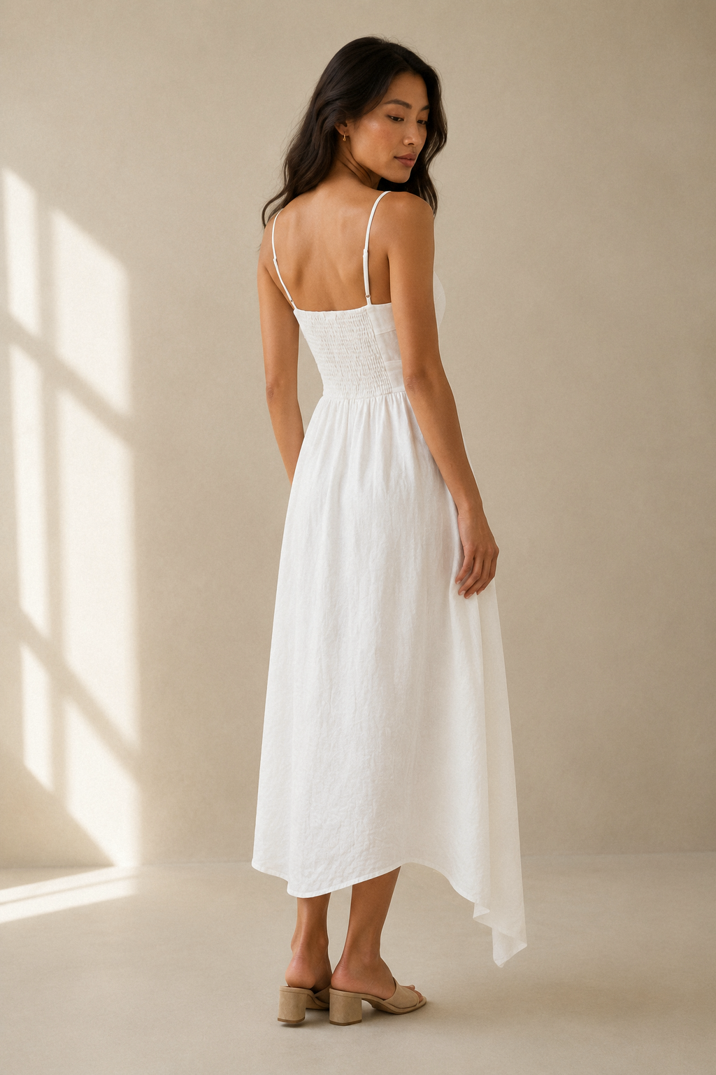 White linen a-line midi dress, back view, fitted bodice and skirt volume