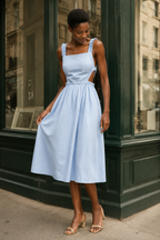 Light blue cotton a-line midi dress, front view, straight neckline and gathered skirt