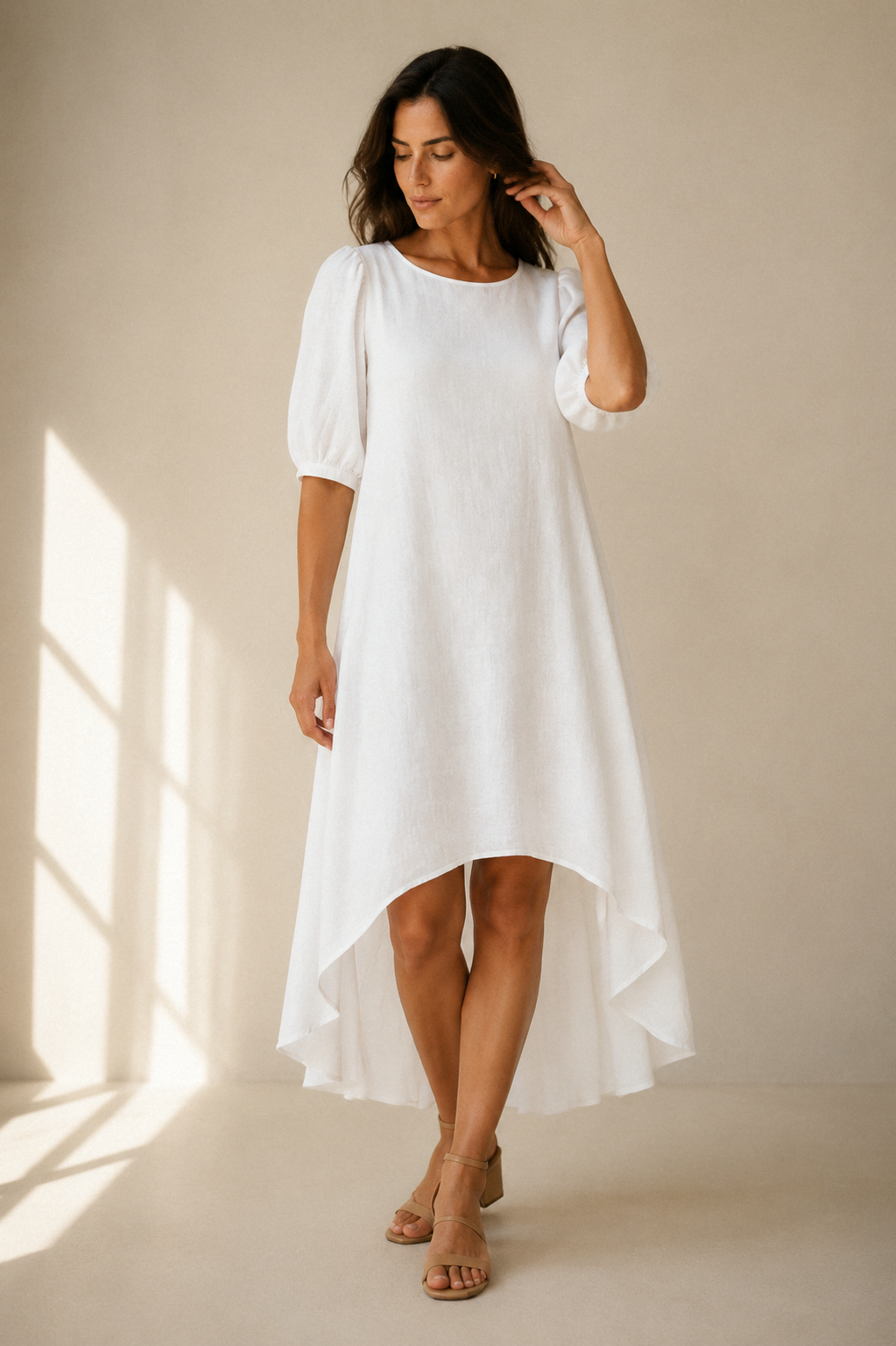 White linen high-low midi dress, full front view, relaxed silhouette, flowing linen fabric