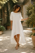White linen high-low midi dress, front view, round neck, puff sleeves, high-low hem